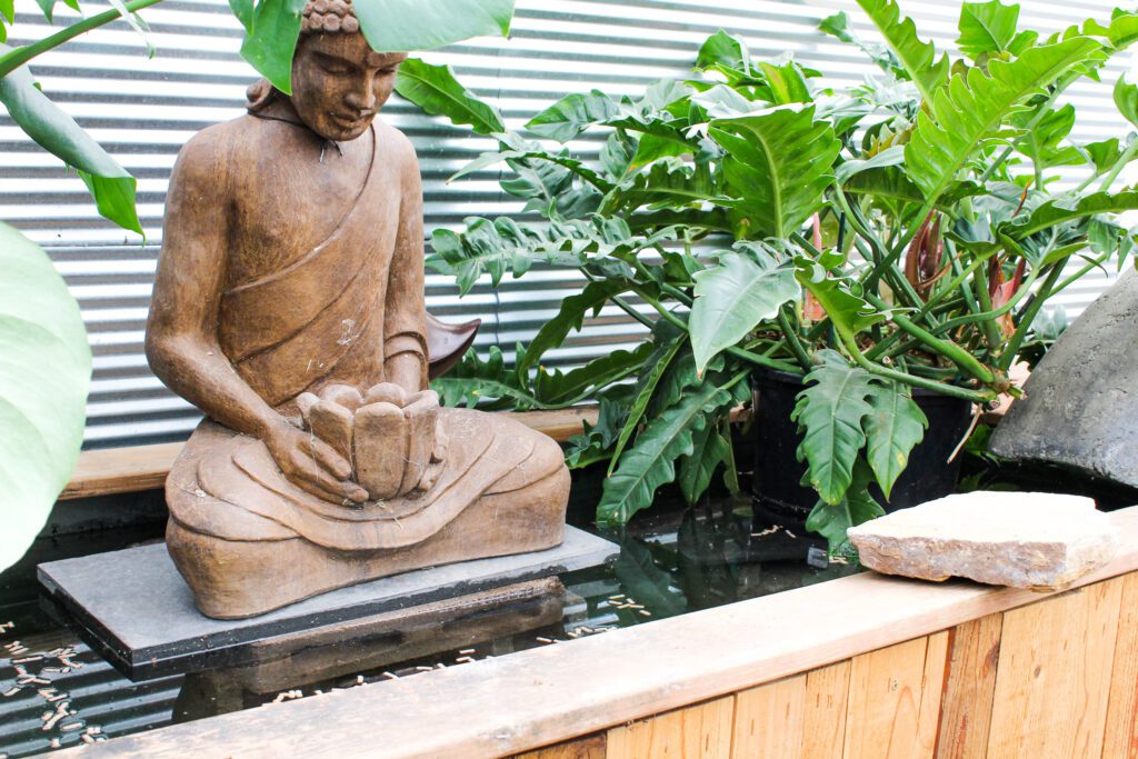Pond with statue and tropical plants | City Floral Garden Center - Denver